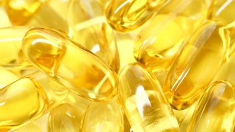 4K closeup Omega 3 fish oil pills background, vitamin E natural capsules texture 스톡 동영상 153826365