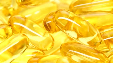 4K closeup Omega 3 fish oil pills background, vitamin E natural capsules texture Stockbeeldmateriaal 155473345
