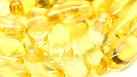 4K closeup Omega 3 fish oil pills background, vitamin E natural capsules texture Stockbeeldmateriaal 155872306