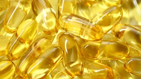 4K closeup Omega 3 fish oil pills background, vitamin E natural capsules texture Stock Footage 156641744