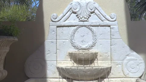 4K Closeup Pan of White Stone Wall Mounted Fountain Stock-Footage 109373762