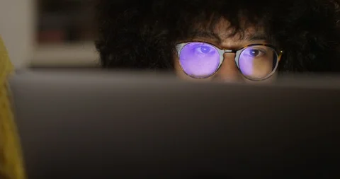 4K Closeup panning shot, young man staring at computer screen late at night  Stock Footage 87117217
