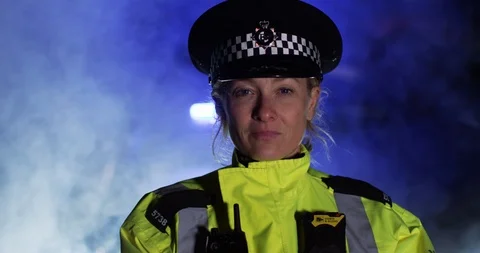 4K Closeup portrait of UK policewoman looking at camera with serious expression Stock Footage 113682797