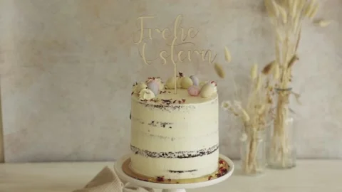4K closeup shot of a delicious Easter Frohe Ostern Naked Cake on a white Stock Footage 150789729