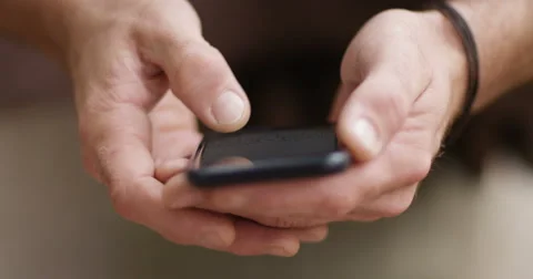 4k, Closeup shot of a man texting on a cellphone outside Stock Footage 67773141