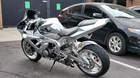 4K closeup video of custom silver Yamaha sport motorcycle parked on asphalt Video stock 314372135