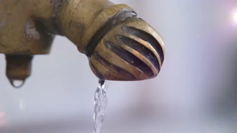 4k, Closeup view. Water is flowing from a tap outside. Drinking water dripping Stock Footage 203984255