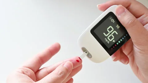 4K Closeup of a woman hand checking blood sugar level with glucometer Stock Footage 314587983
