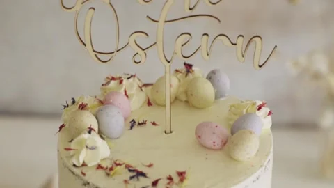 4K closeupshot of a delicious Easter Frohe Ostern Naked Cake on a white Stock Footage 150789714