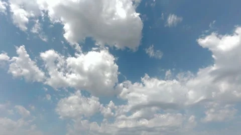 4K Cloud Timelapse: Fluffy White Clouds Moving Fast Across Bright Blue Sky Stock Footage 331909717