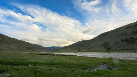 4K. Clouds above the Khovd river, Mongolian Altai, Mongolia. Ultra HD, 4096x2 Stock Footage 107023907