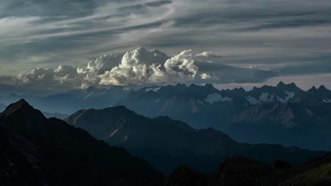 4k Clouds rolling over the great mountain range in the sunset Timelapse Stock Footage 87323481
