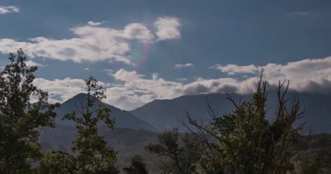 4k Clouds time lapse Billowing over mountain peaks at night Stock Footage 41669633