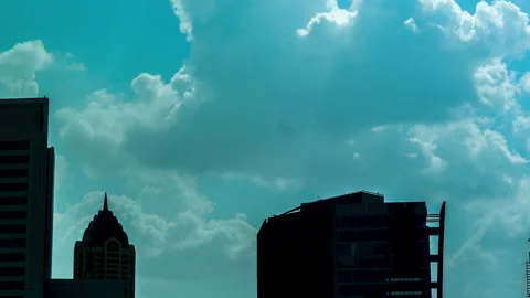 4K Clouds Time Lapse Blue Teal sky, fluffy clouds moving, skyscrapers buildings Stock Footage 286217481