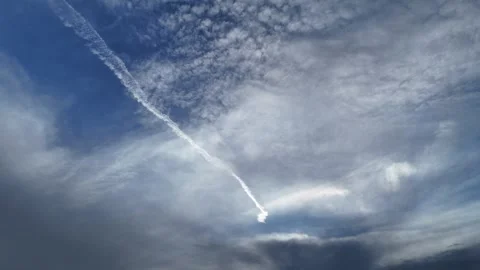 4K Cloudy Sky With Sunlight and Airplane Contrail Stock Footage 333928307