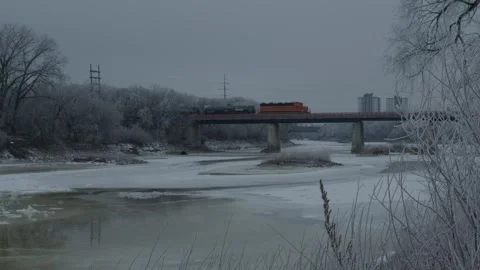 4k A CN train passing over the Red River Winter in Canada  库存影片 296849980
