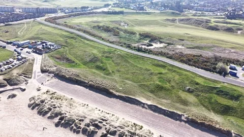 4K coastal motion across sandy beach shoreline with shifting tidal water and Видео 337307815