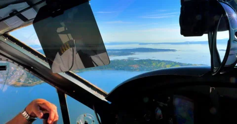 4K Cockpit of Small Plane, Pilot's Hand, Flying Aircraft over Pacific Islands Stock Footage 62089621