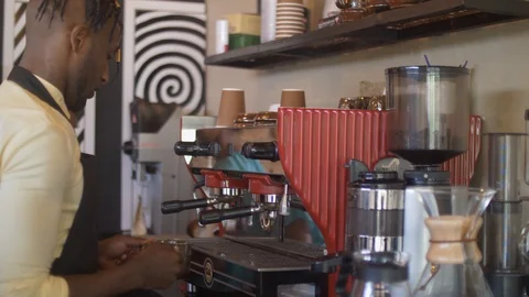 4k coffee shop worker preparing a cup for coffee at a busy coffee shop. Stock Footage 111339249