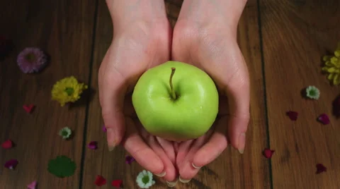 4k Colourful Composition of Fresh Apple in Hand - Wooden Background Stock Footage 66569464