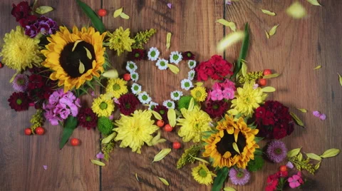 4k Colourful Composition of Fresh Flowers Heart - Wooden Background Stock Footage 66658087