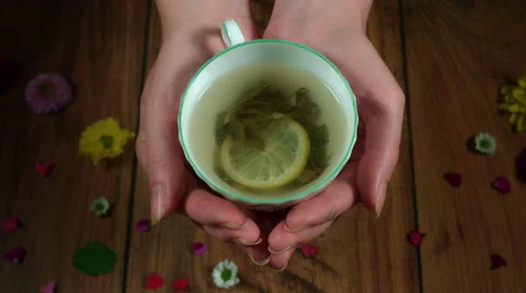 4k Colourful Composition of Fresh Green Tea in Hand - Wooden Background Vídeo Stock 66587980