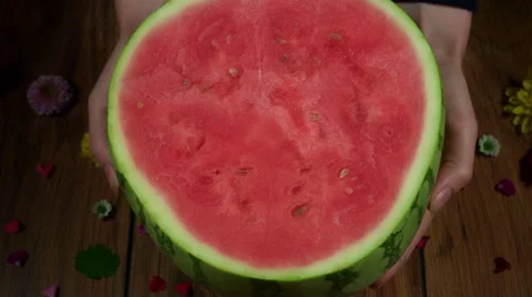 4k Colourful Composition of Fresh Watermelon in Hand - Wooden Background Stock Footage 66587801