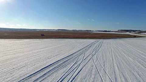 4K. Combine Harvester is working in the corn field after the First Snow! Aerial. Video stock 69769995