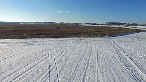 4K. Combine Harvester is working in the corn field after the First Snow! Aerial. Video stock 69770045