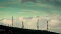 4K communication towers on mountain top at sunrise clouds passing HD Footage