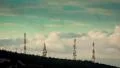 4K communication towers on mountain top at sunrise clouds passing 4k or 4k+ Resolution
