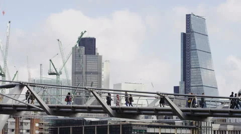 4K Commuters walking on Millennium Bridge, City of London in the background 55885553