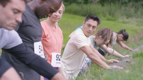 4K Competitive team in assault course race getting ready at the starting line Stock Footage 65740571