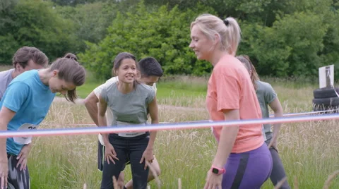 4K Competitive team in assault course race warming up at the starting line Stock Footage 65743822