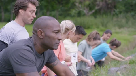 4K Competitive team in assault course race getting ready at the starting line Stock Footage 65760282