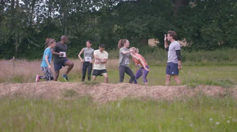 4K Competitive team in assault course race warming up at the starting line. Stock Footage 66083211