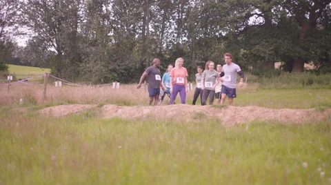 4K Competitive team in assault course race warming up at the starting line Stock Footage 66112120