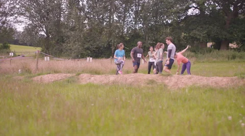4K Competitive team in assault course race warming up at the starting line Stock Footage 66112288
