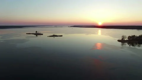 4K Compilation Video. Flight over frozen lake with bridge in spring on sunset. Stock-Footage 85574560