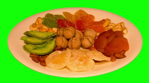 4k – Composition of different dried fruit and nuts on plate Stock Footage 56838659