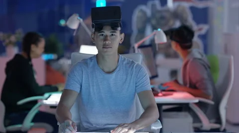 4K Computer game designer looks directly into camera before putting on VR viewer Stock Footage 67546155