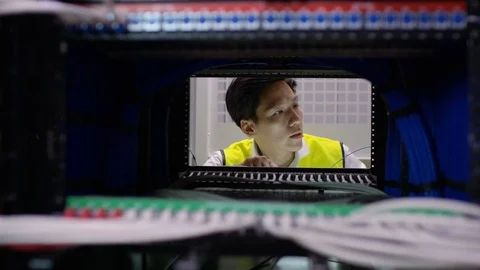 4K Computer technician checking the equipment in a data center server room Stock Footage 75045316