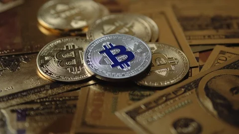 4k concept vidoe. Camera moving around bitcoin coins and golden money dollars Video stock 104326231