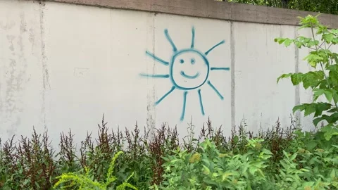 4k Concrete wall with painted smiling sun on it. Stock Footage 158215073