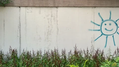 4k Concrete wall with painted smiling sun on it. Stock Footage 158532792
