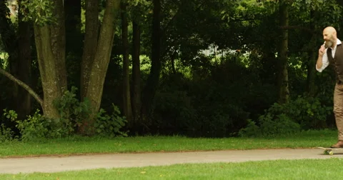 4k, Confident executive on skateboard outdoors. Slow motion. Stock Footage