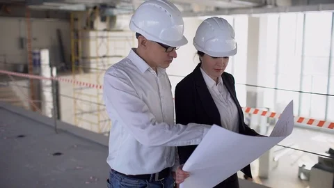 4k Confident female engineer or architect discussing construction issues with Stock Footage 85910237