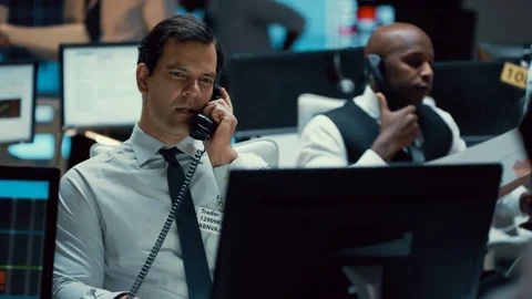4K Confident stock market trader doing deals over the phone Stock Footage