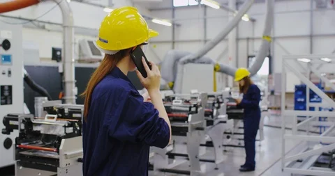 4K Confident young industrial manager making a phone call on the factory floor. Stock Footage 101953611
