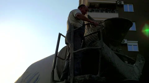 4K, Construction worker looking inside a cement truck Stock Footage 53226995